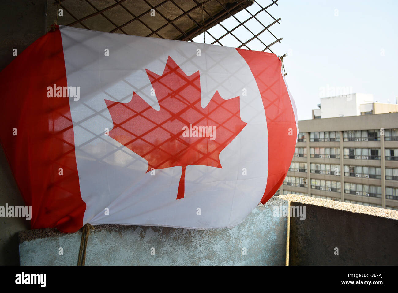 Canadian flag against a chain link fence Stock Photo