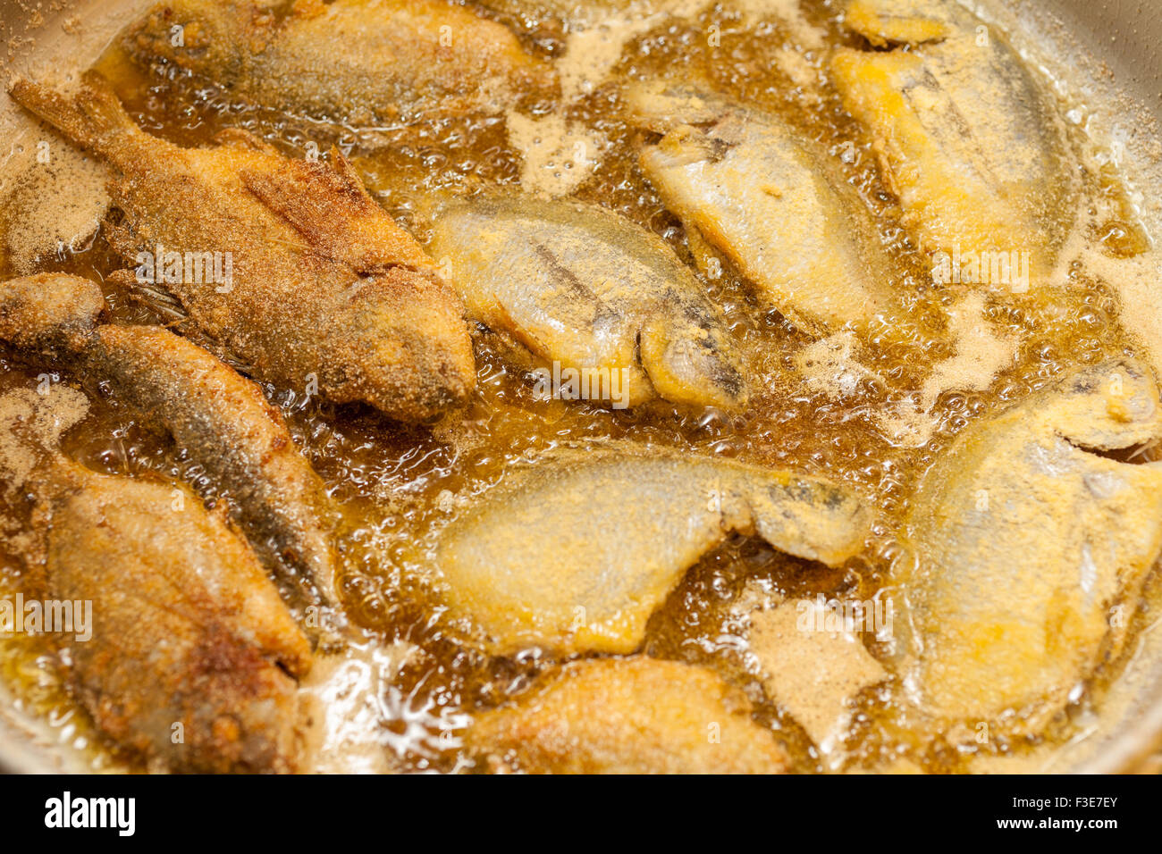 Small fishes of the Greek sea roasted in the frying pan Stock Photo