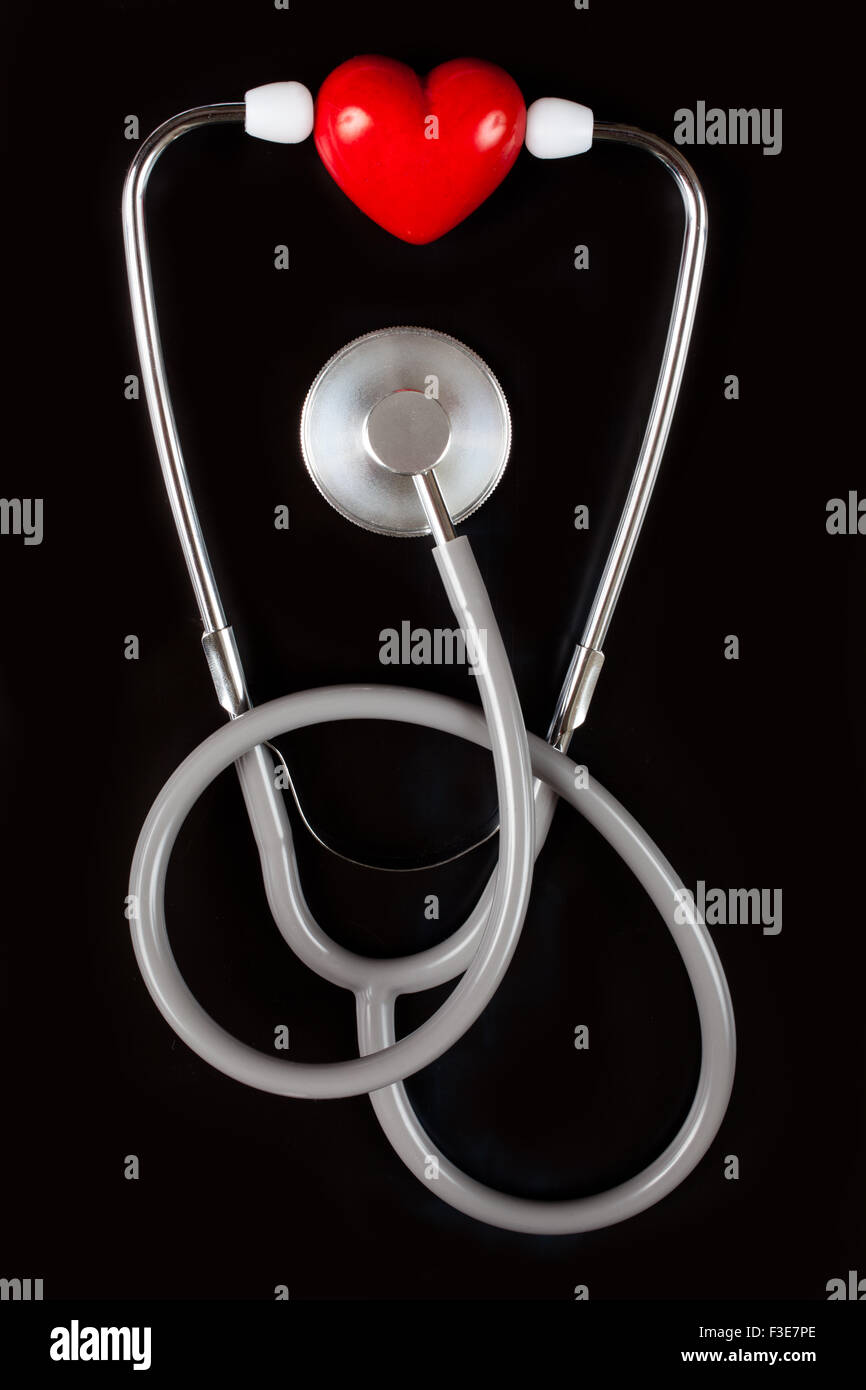 Stethoscope & red heart on black background Stock Photo - Alamy