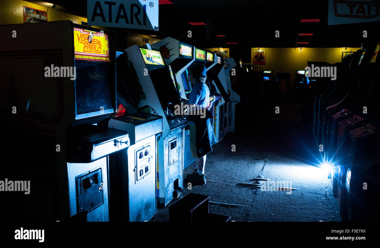A boy plays video games in the American Classic Arcade Museum in