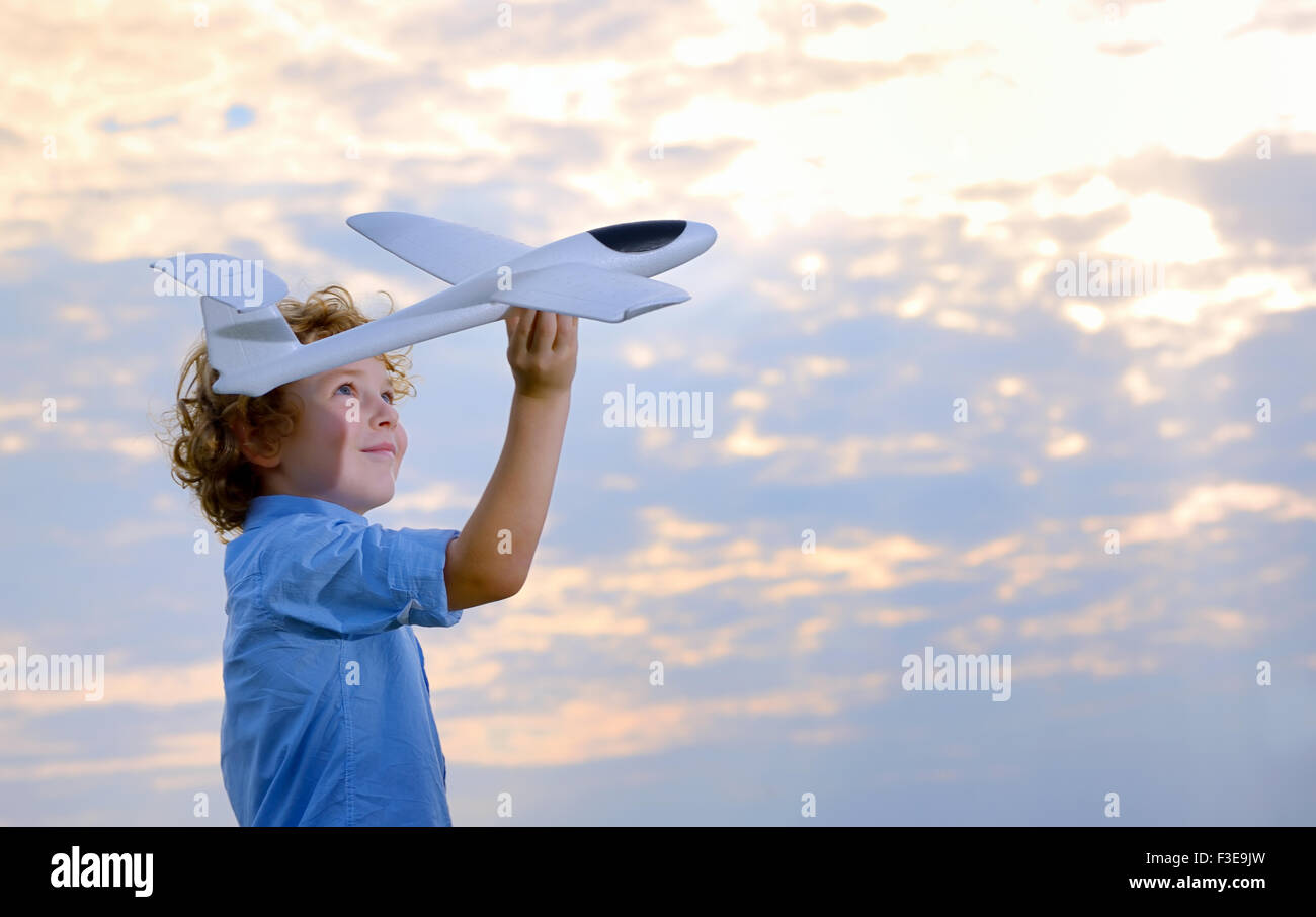 boy throwing airplane in the field Stock Photo Alamy