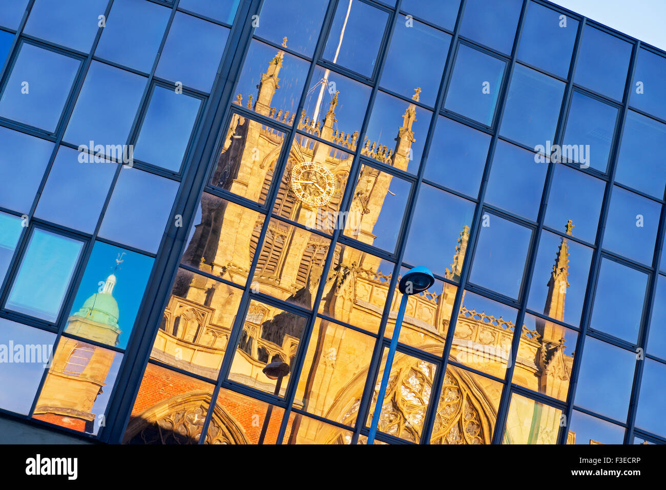 Holy Trinity Church, Hull, reflected in glass-fronted office block, Kingston upon Hull, East Riding of Yorkshire, England UK Stock Photo