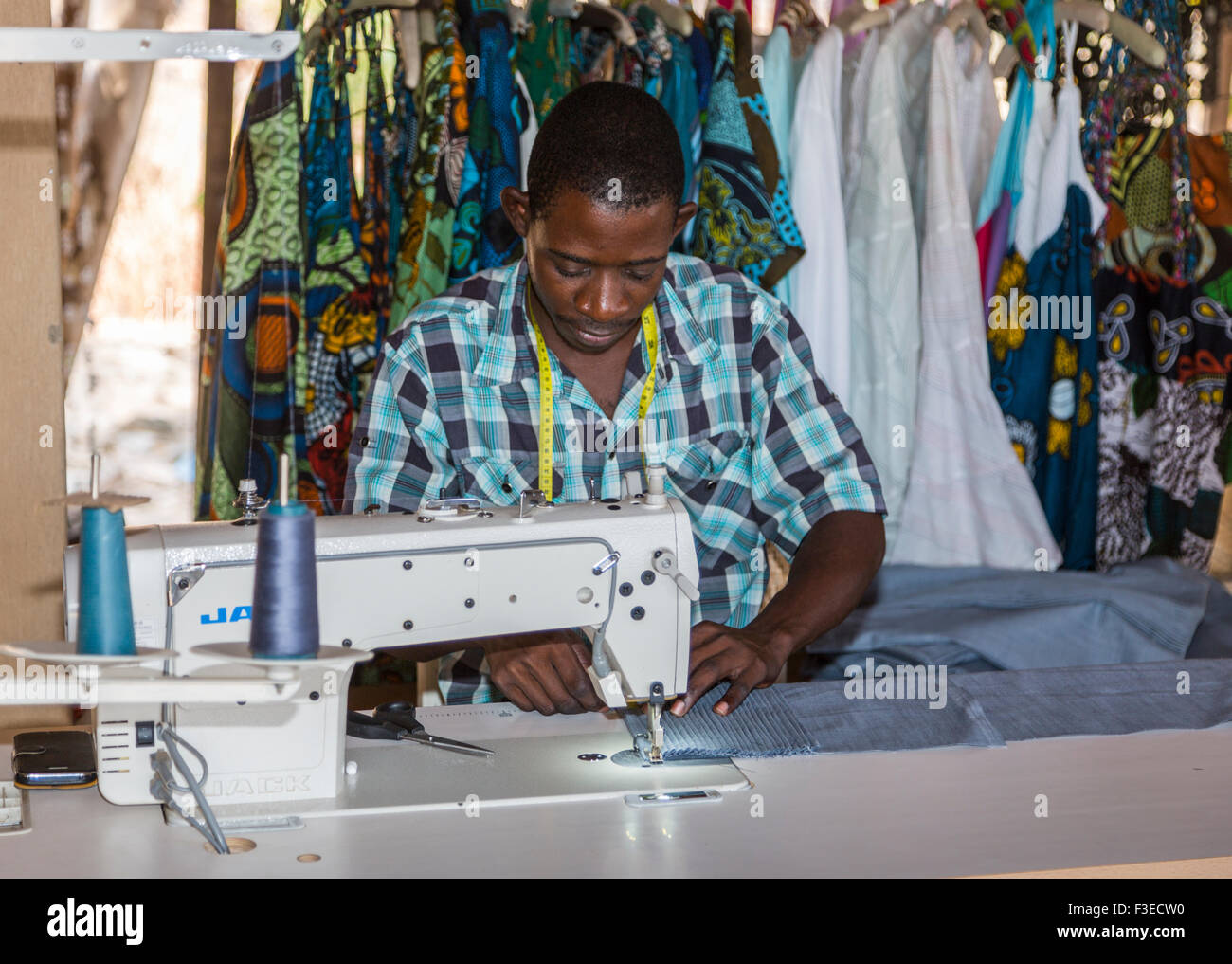 Local African man sewing with a sewing machine at Katundu creative