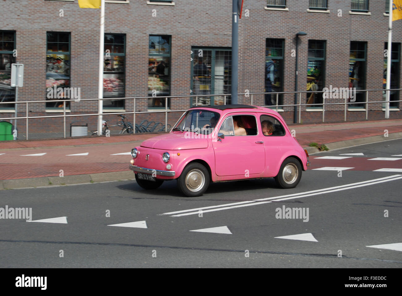 Classic pink Fiat 500 on the move Stock Photo Alamy