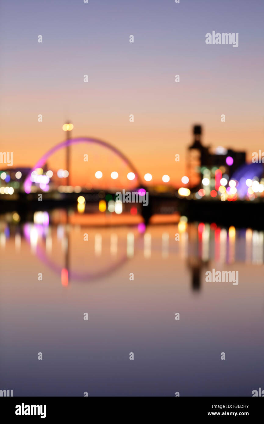 Defocused abstract Clyde Arc Bridge reflected in the River Clyde at sunset, Glasgow, Scotland, UK Stock Photo