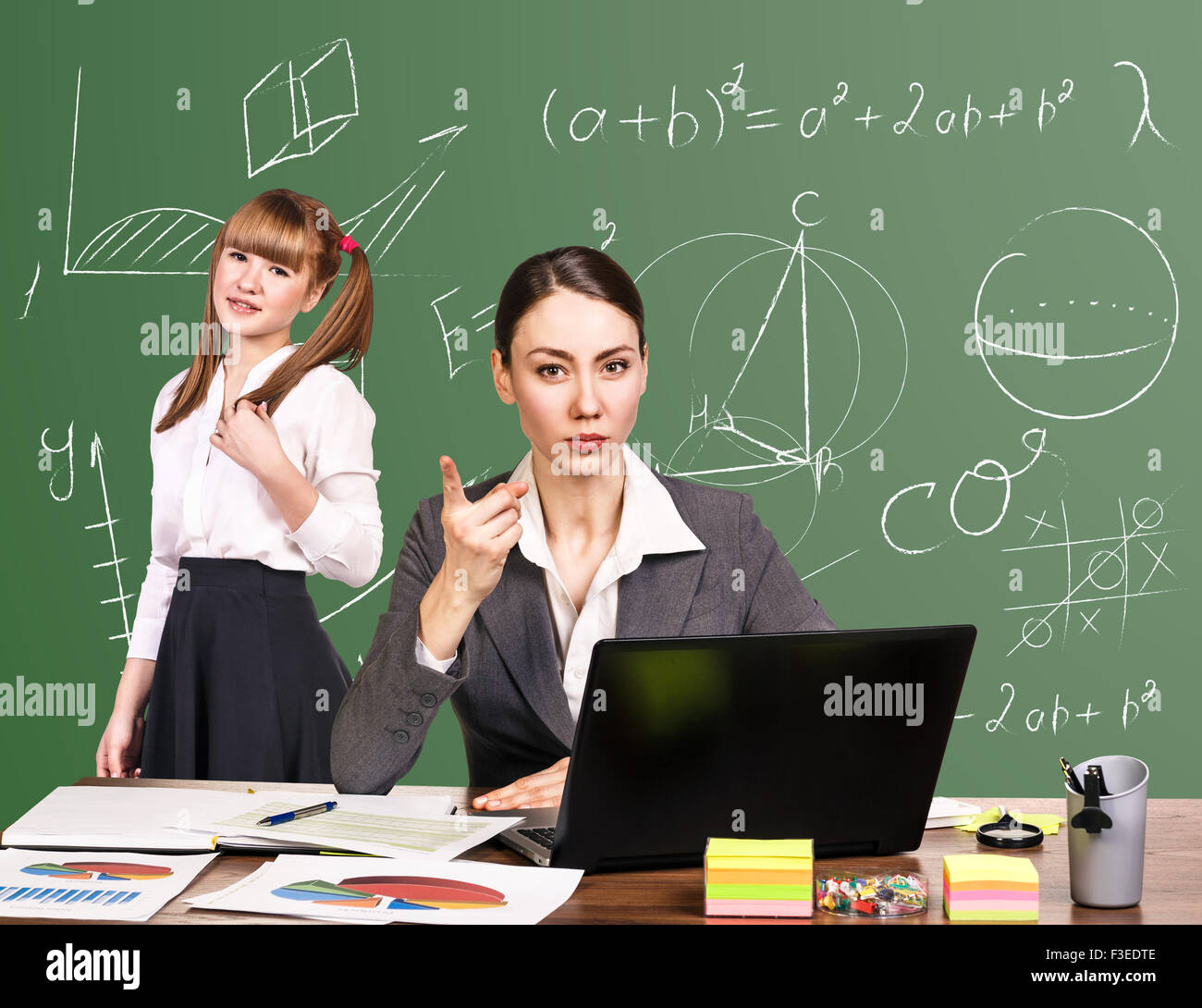 Teacher sitting at the desk Stock Photo - Alamy