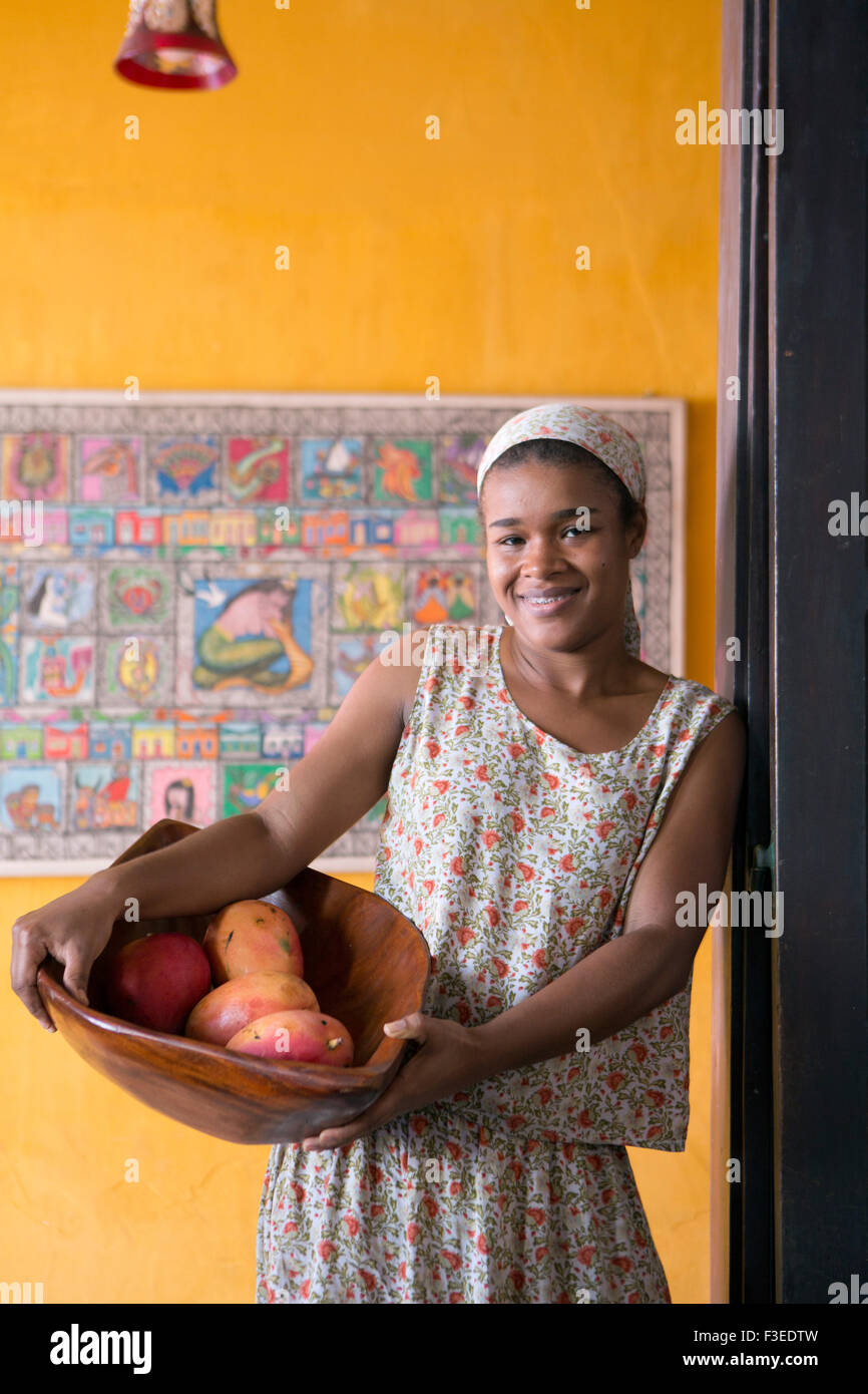 Bahian girl carrying a bowl of mangoes Stock Photo