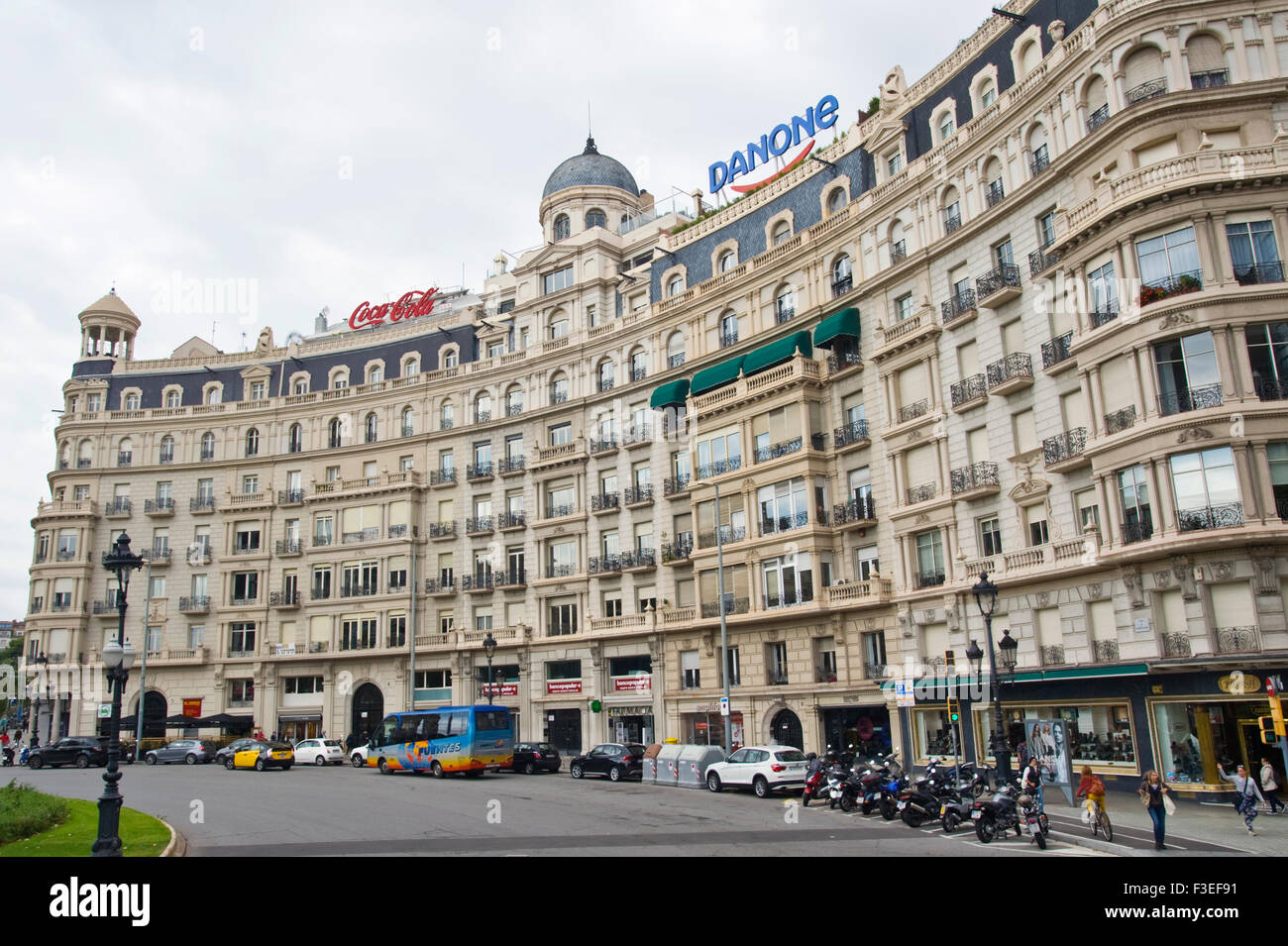 Exterior of modern apartments with balconies above shops in Barcelona ...