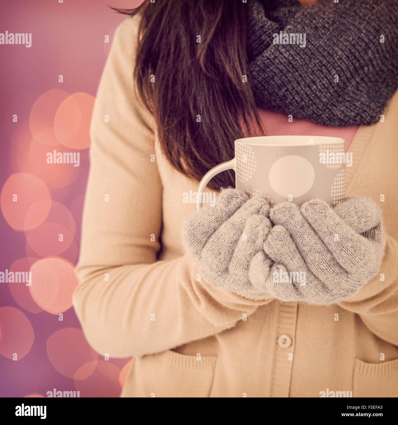 Composite image of woman holding polka dotted mug Stock Photo