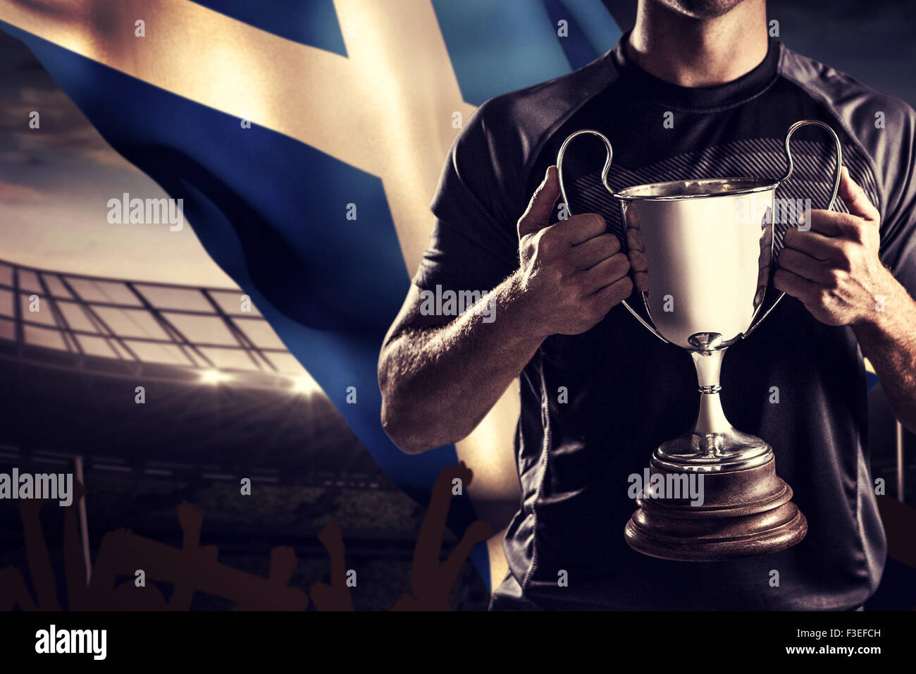 Composite image of victorious rugby player holding trophy Stock Photo