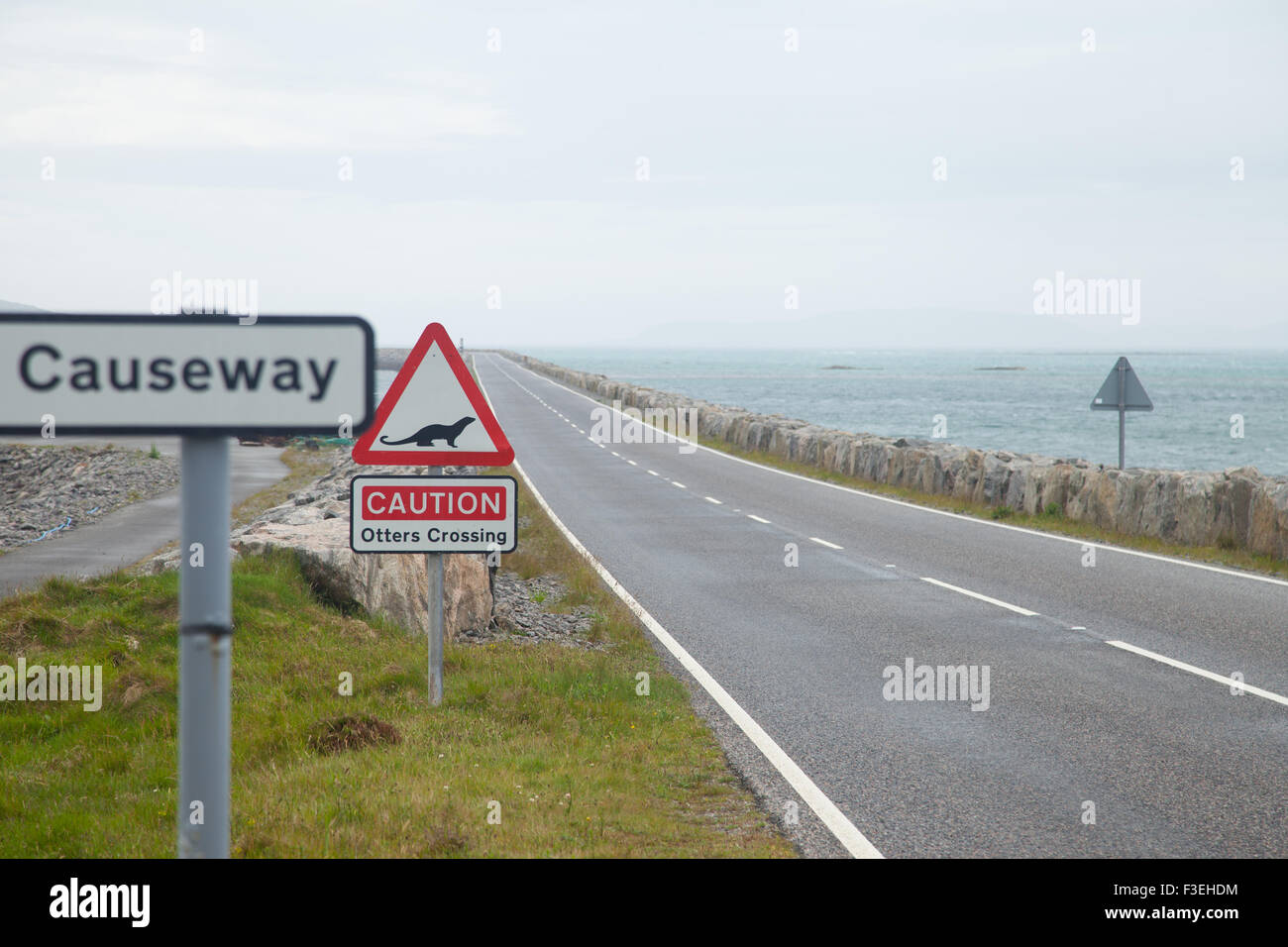 A caution Otters crossing sign on the start of the South Uist to Eriskay causeway, Outer Hebrides, Scotland. Stock Photo