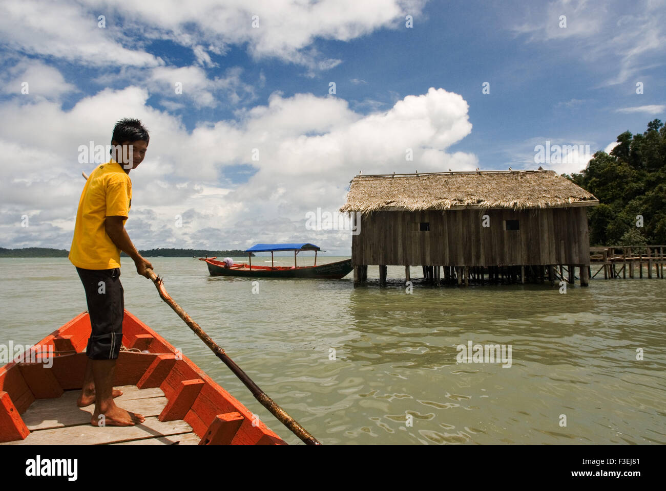 Hut in the Ream National Park. A red boat approaches. Ream National Park is 18 kilometres from downtown Sihanoukville, towards P Stock Photo