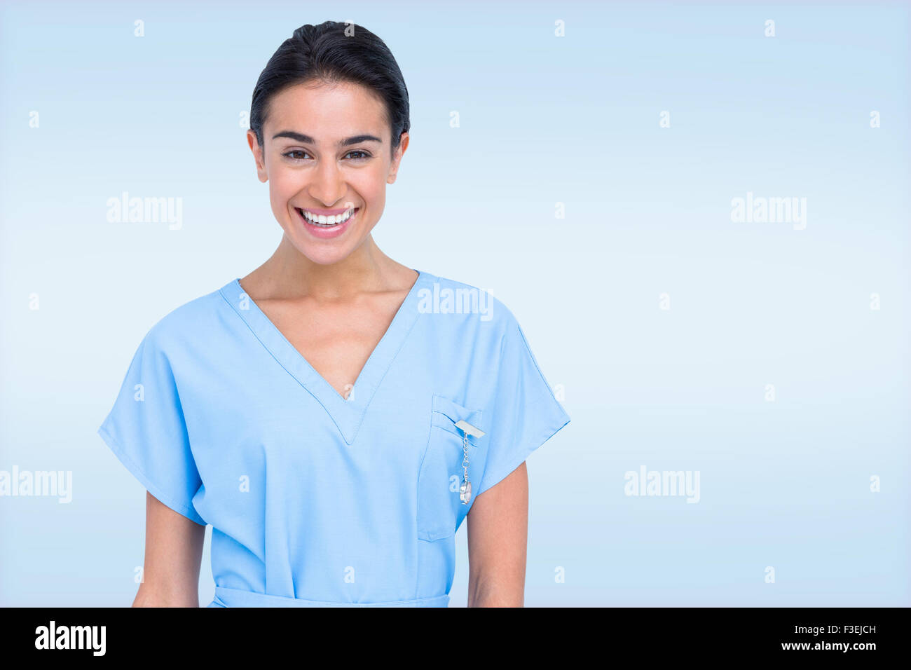 Composite image of young nurse in blue tunic Stock Photo
