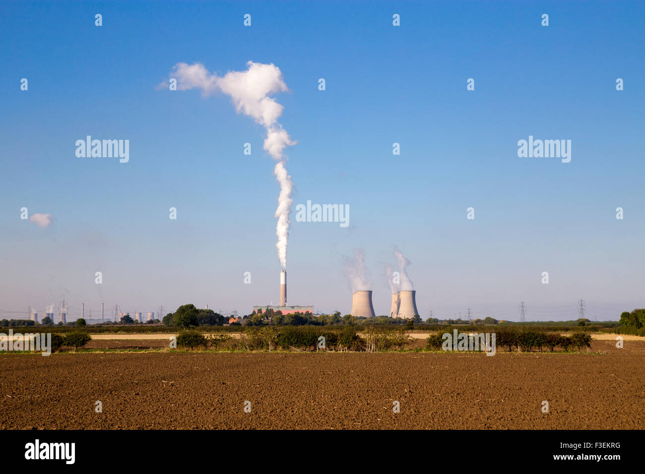 Stock photograph of Cottam power station with steam / smoke emissions rising into the sky from the cooling towers.  West Burton Stock Photo