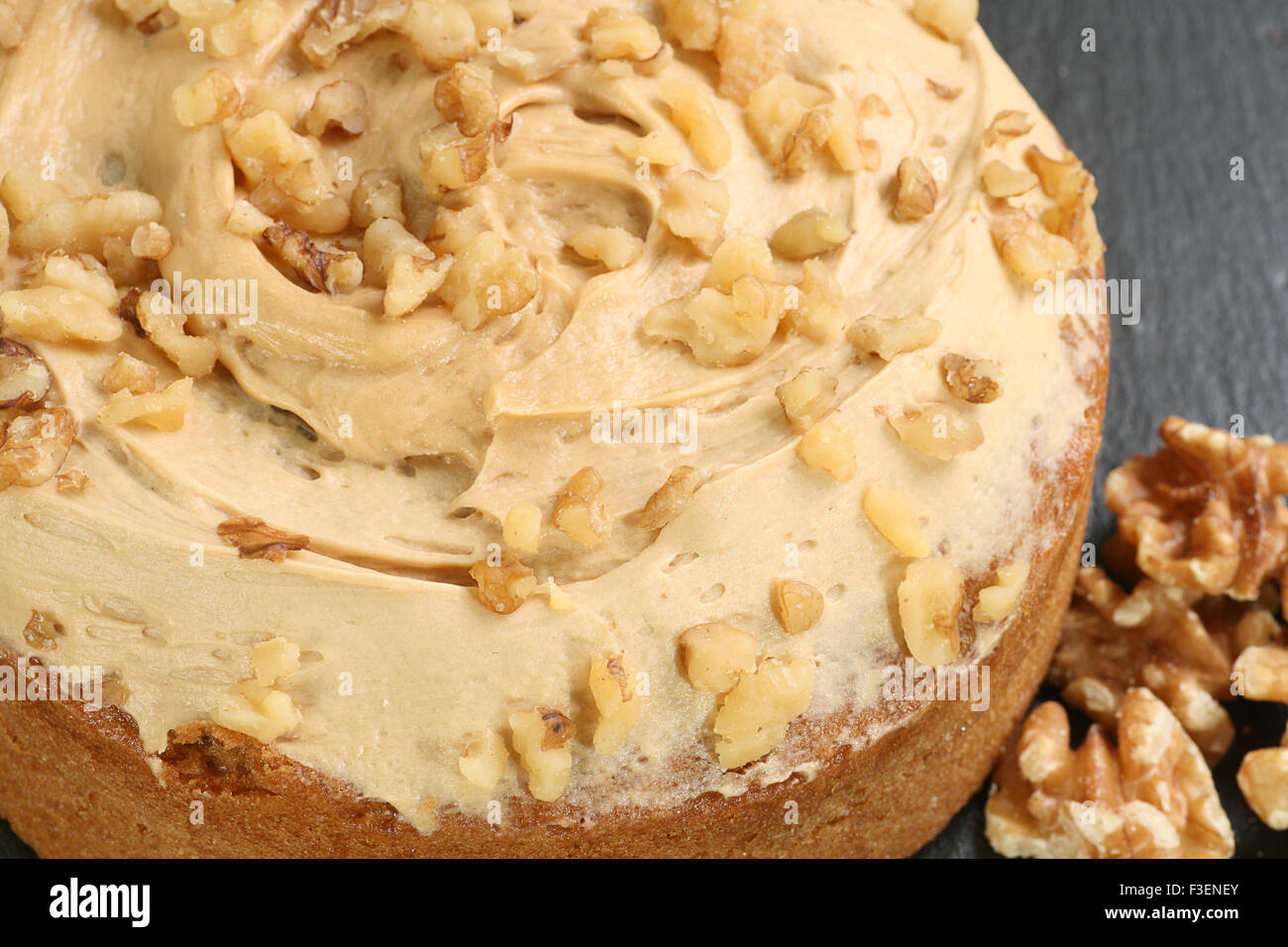 whole walnut and coffee cake with butter icing Stock Photo
