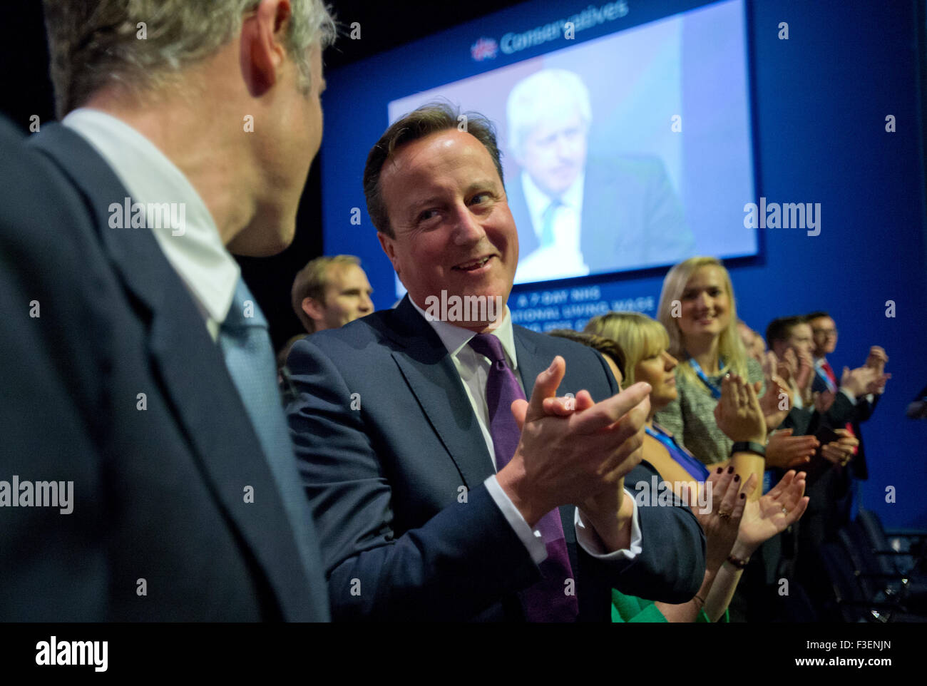 Manchester, UK. 6th October 2015. Zac Goldsmith MP, Conservative Party Candidate for London Mayor (left), and The Rt Hon David Cameron MP, Prime Minister, applaud Boris Johnson, Mayor of London, following his speech during Day 3 of the 2015 Conservative Party Conference in Manchester. Credit:  Russell Hart/Alamy Live News. Stock Photo