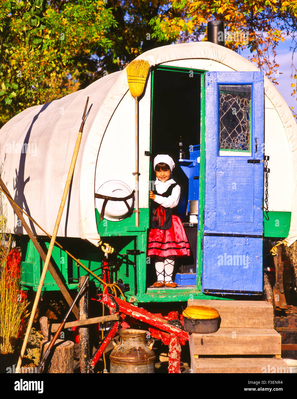 Portrait of basque girl in traditional clothing standing in the doorway of Sheephearders Wagon, Boise, Idaho, USA Stock Photo