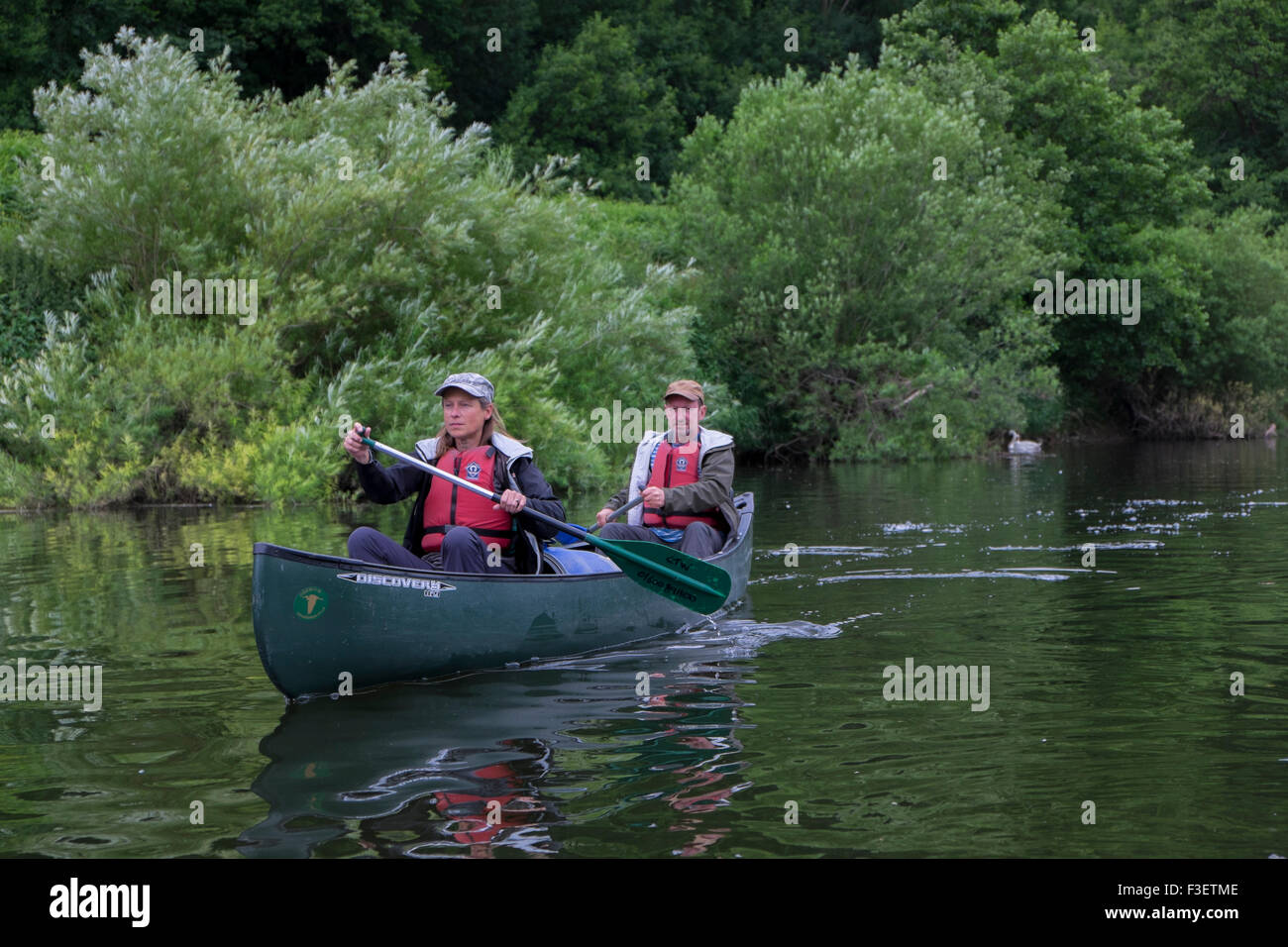 50 year old couple paddling kayak canoe on River Wye near Symonds Yat, Herefordshire, England, UK Stock Photo