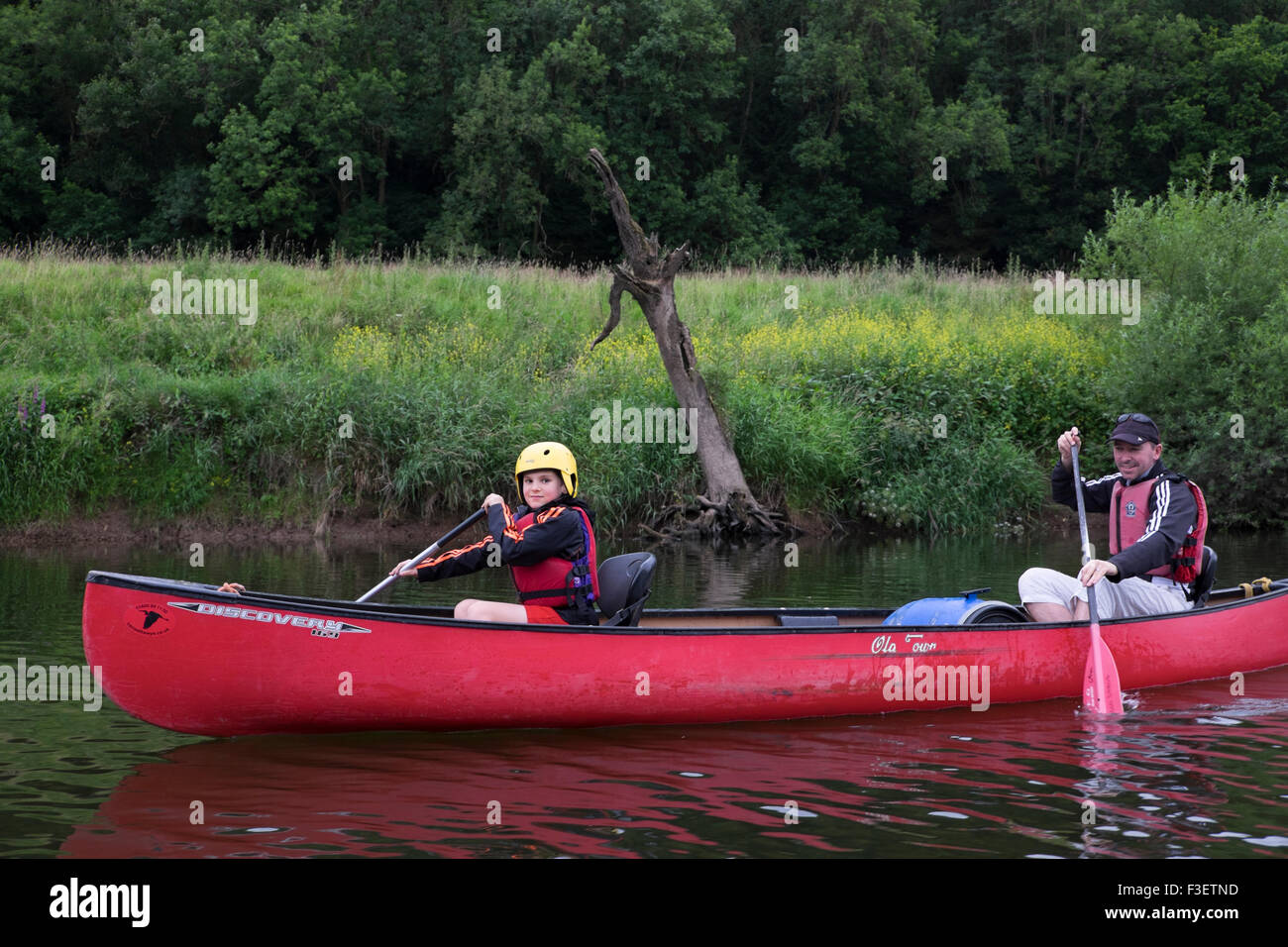 Father with 8 year old son paddling kayak canoe on River Wye near Symonds Yat, Herefordshire, England, UK Stock Photo