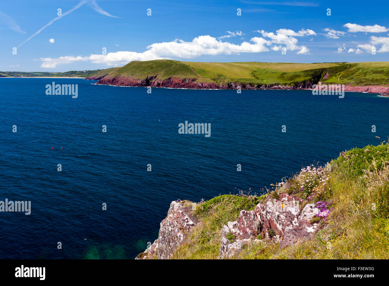 The colourful red sandstone coastline near Manorbier Bay in the Pembrokeshire Coast National Park, Wales, UK Stock Photo