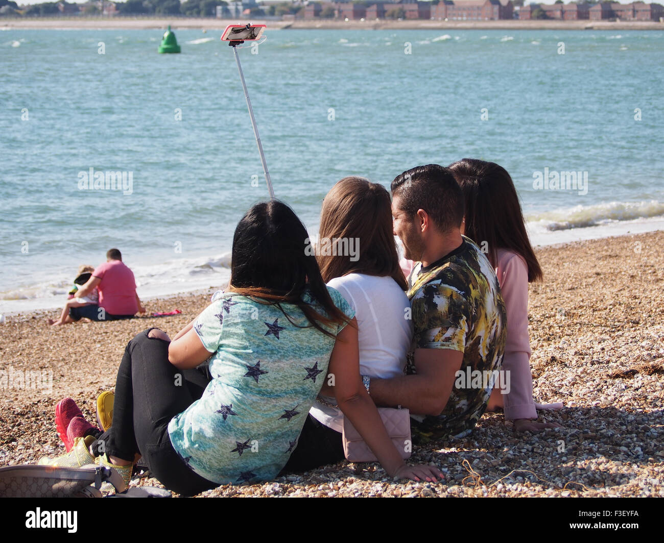 A group of young people taking selfie photographs on the beach Stock Photo