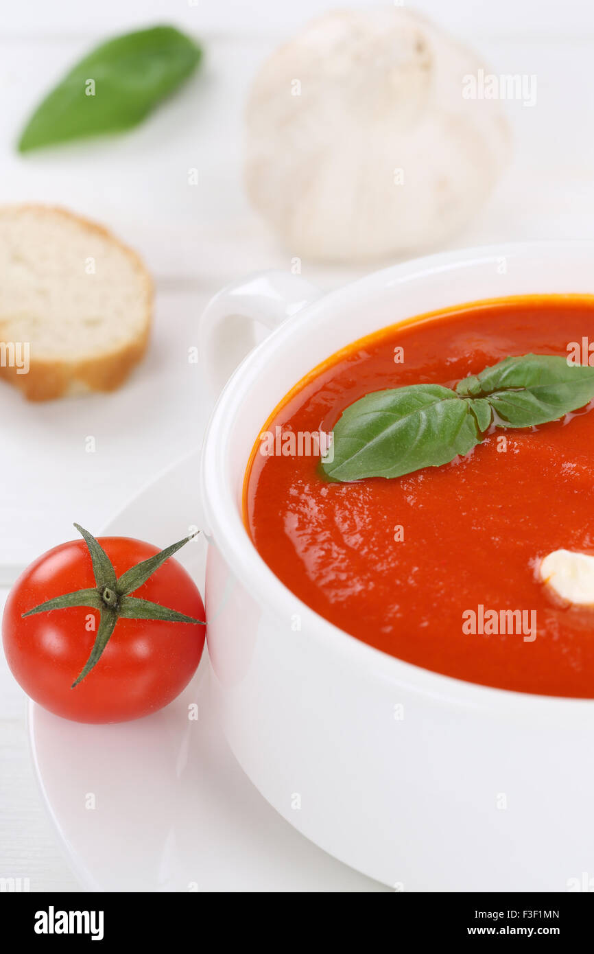 Tomato soup meal with fresh tomatoes and baguette in bowl Stock Photo
