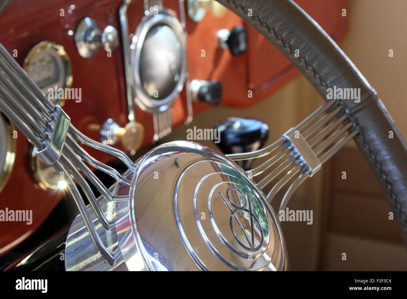 Steering wheel and instrument cluster of a classic car. Stock Photo