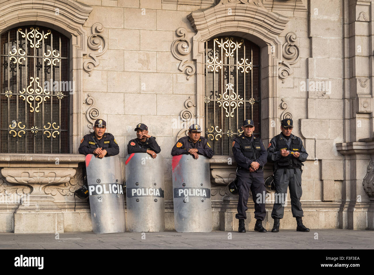 Lima, Peru - September 05, 2015: Five policemen are guarding the central square in front of the government palace on a Saturday Stock Photo