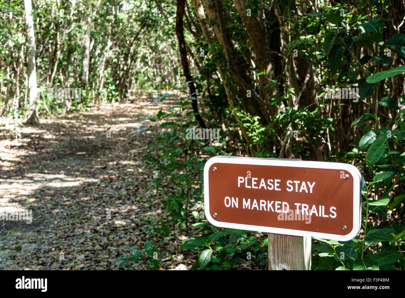 Key Largo Florida Keys,Dagny Johnson Key Largo Hammock Botanical State Park,nature trail,sign,stay on marked trails,FL150508001 Stock Photo
