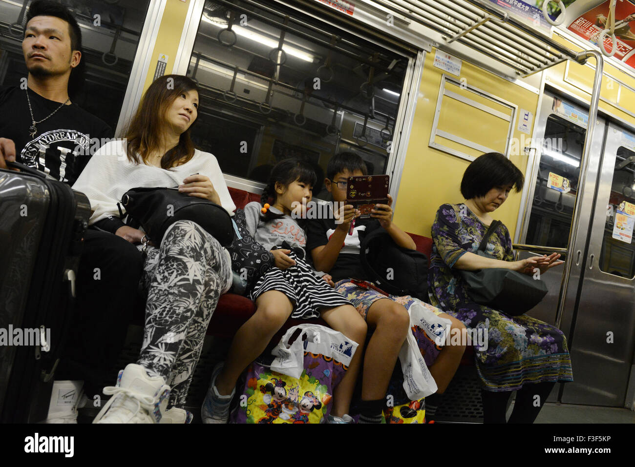 A Japanese family riding the Tokyo Metro. Stock Photo