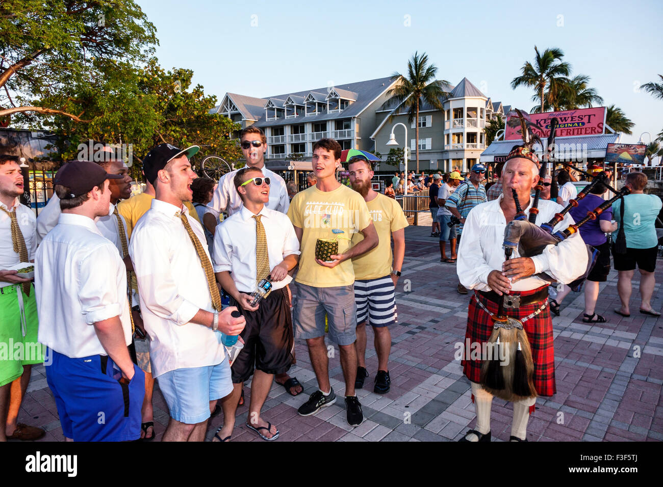 Key West Florida,Keys Mallory Square Dock,sunset celebration,festival,Scottish bagpipes,player,playing man,Georgia Tech Glee Club,chorus,singing,along Stock Photo