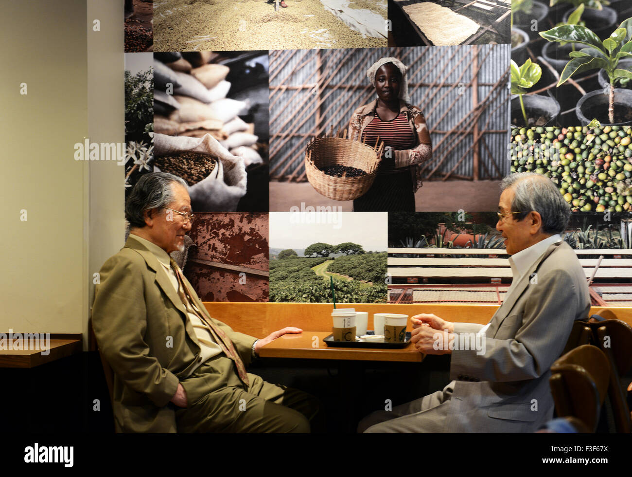 Japanese businessmen sitting in Starbucks in Tokyo Stock Photo Alamy