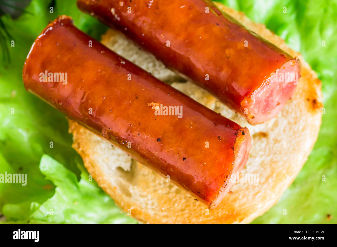Tapas appetizer with smoked sausage on toast top view Stock Photo