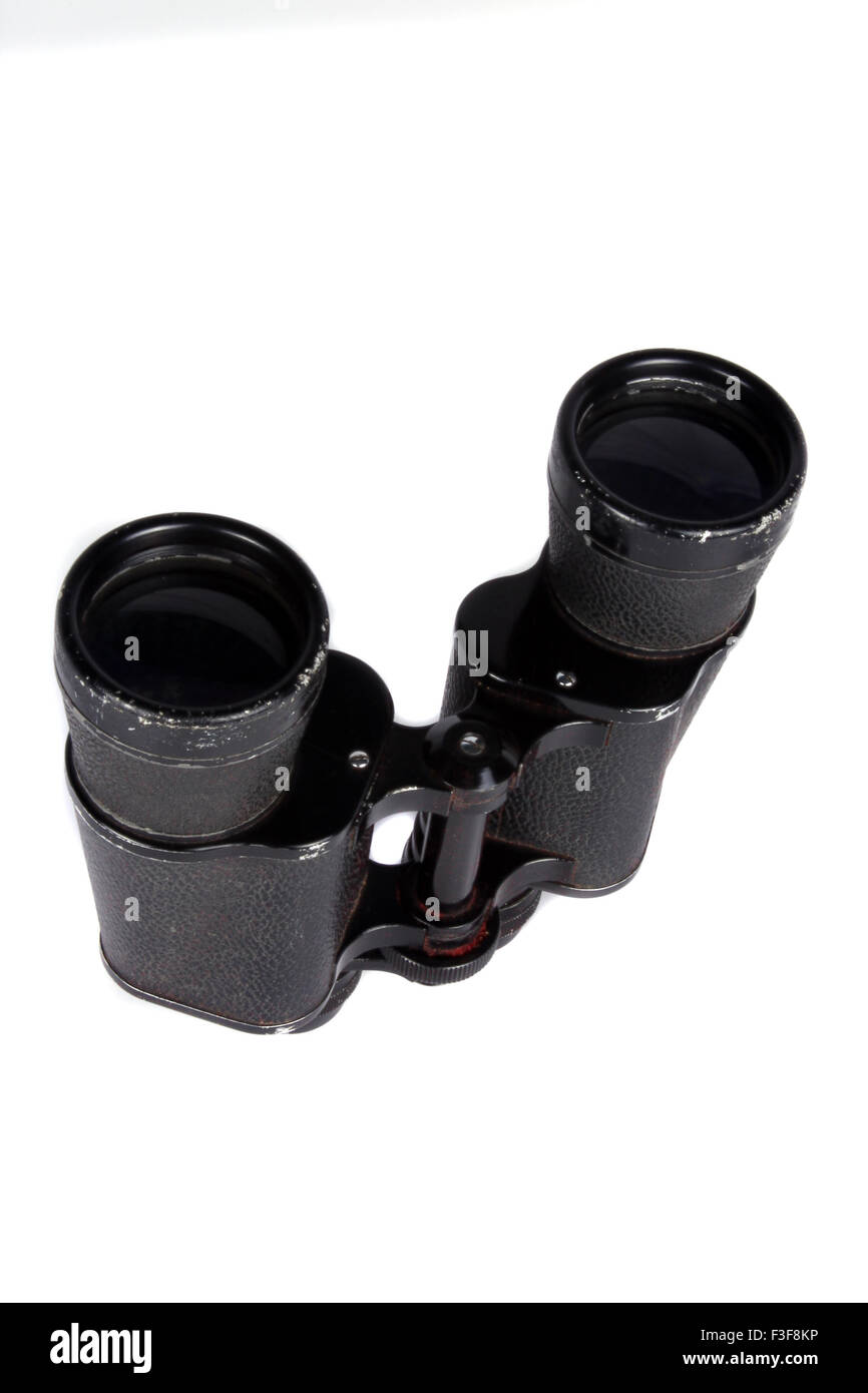 A pair of antique binoculars used in World War 1, on white studio