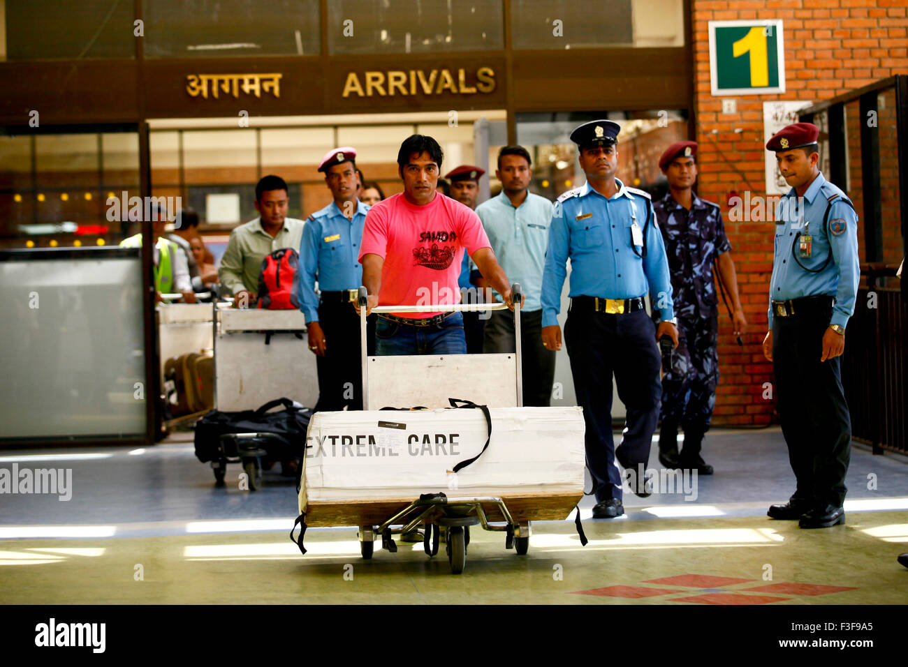 Kathmandu, Nepal. 2nd Oct, 2015. Dolakh Dangi (1st L, front), nephew of the world's shortest man Chandra Bahadur Dangi, walks with Chandra Bahadur's body at an airport in Kathmandu, Nepal, Oct. 2, 2015. Chandra Bahadur Dangi, who was 54.6 cm (21.5 inches) tall according to Guinness World Records, died on Sept. 3 at the age of 75. His body was kept for the last tribute on Oct. 6. © Pratap Thapa/Xinhua/Alamy Live News Stock Photo