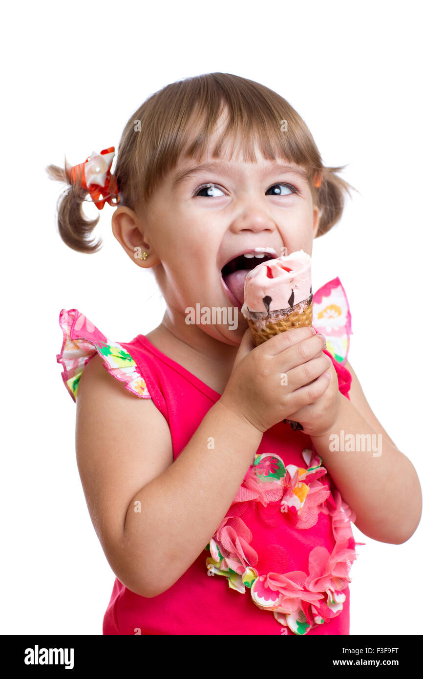 joyful child girl eating ice cream in studio isolated Stock Photo