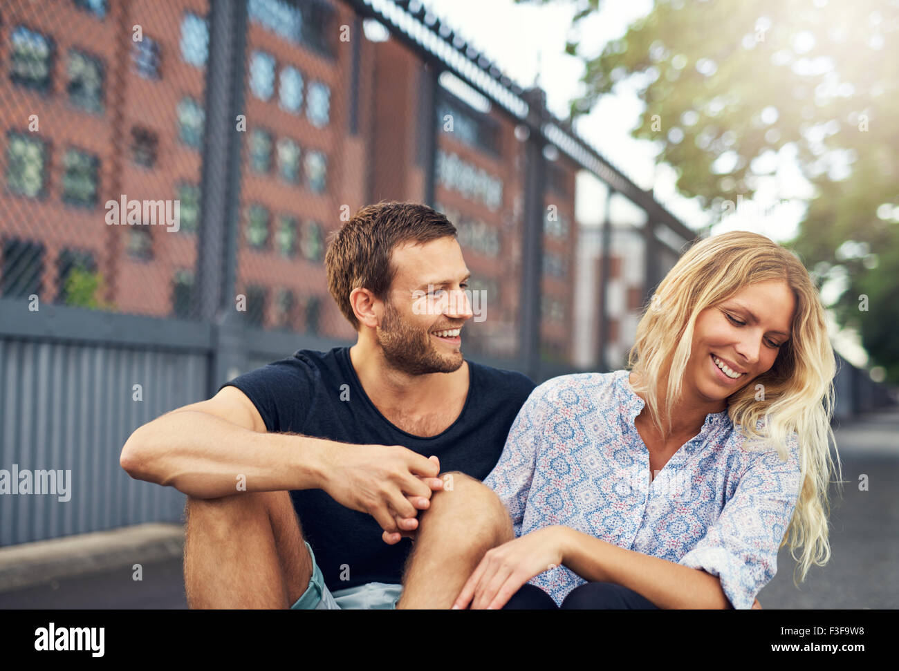 Man teasing his girlfriend, big city couple in a park Stock Photo