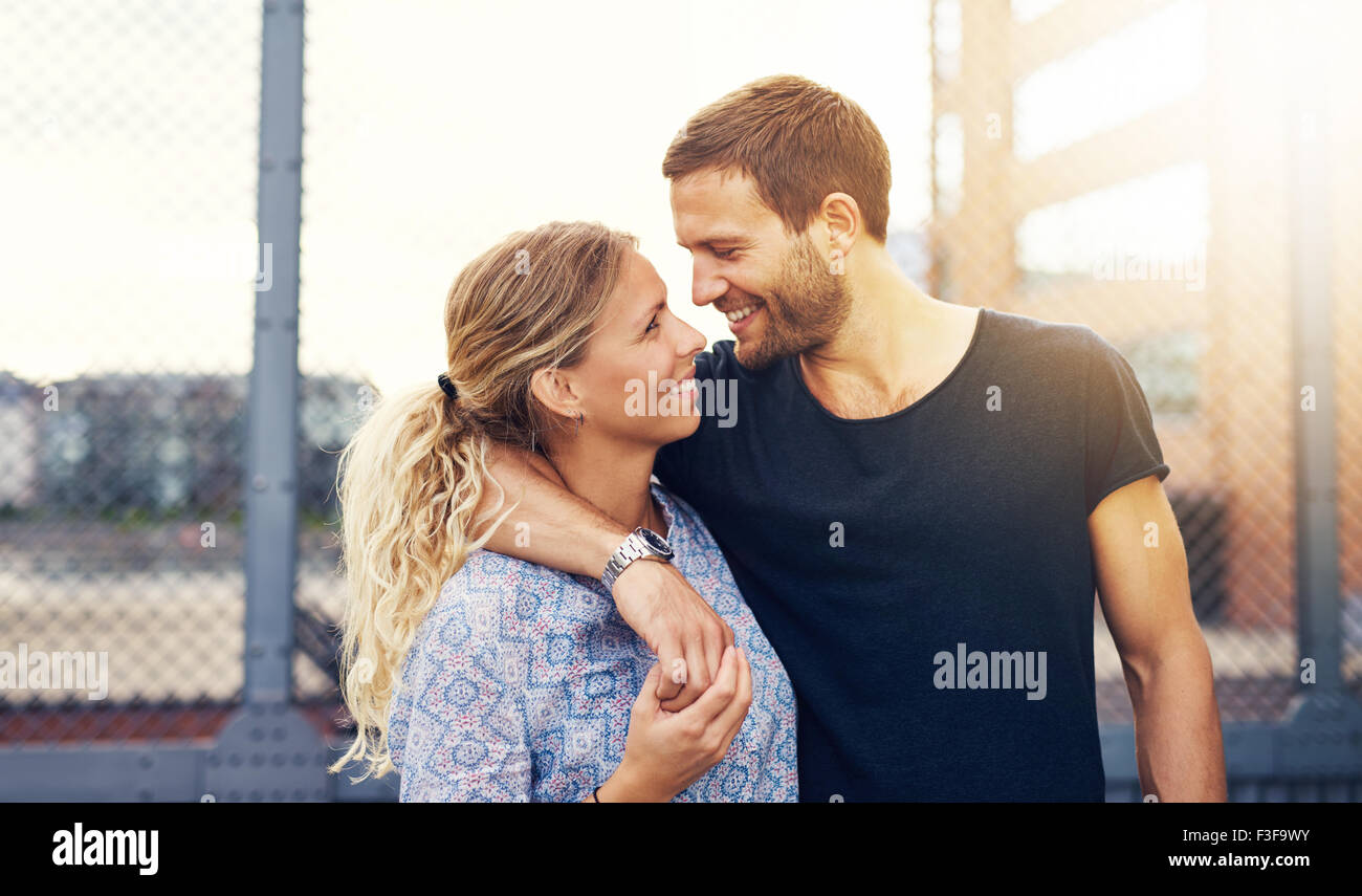 Couple looking into each others eyes while smiling Stock Photo Alamy