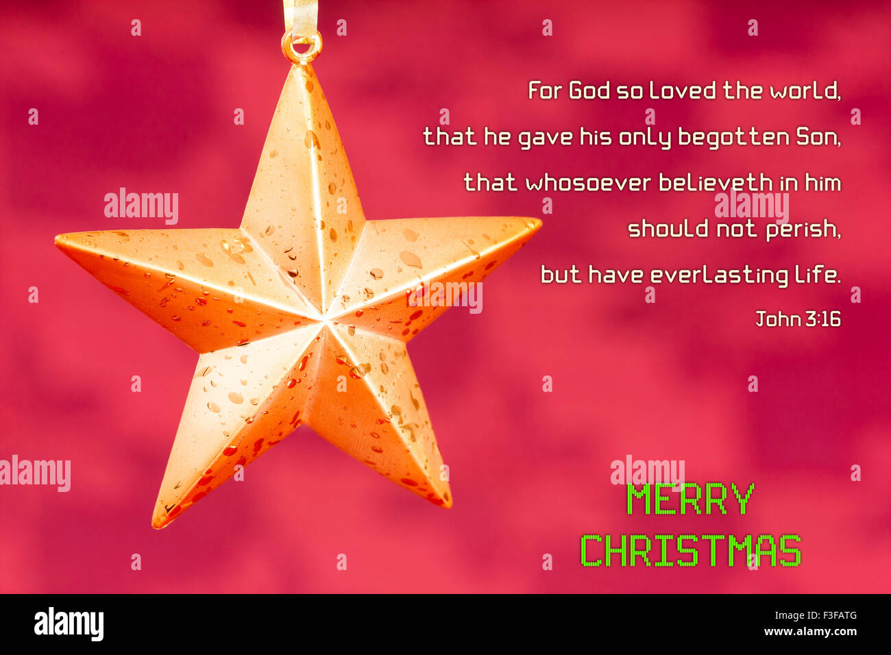 A star shaped Christmas ornament set against a maroon red background. Bible verse John 3:16 is displayed with Christmas message. Stock Photo