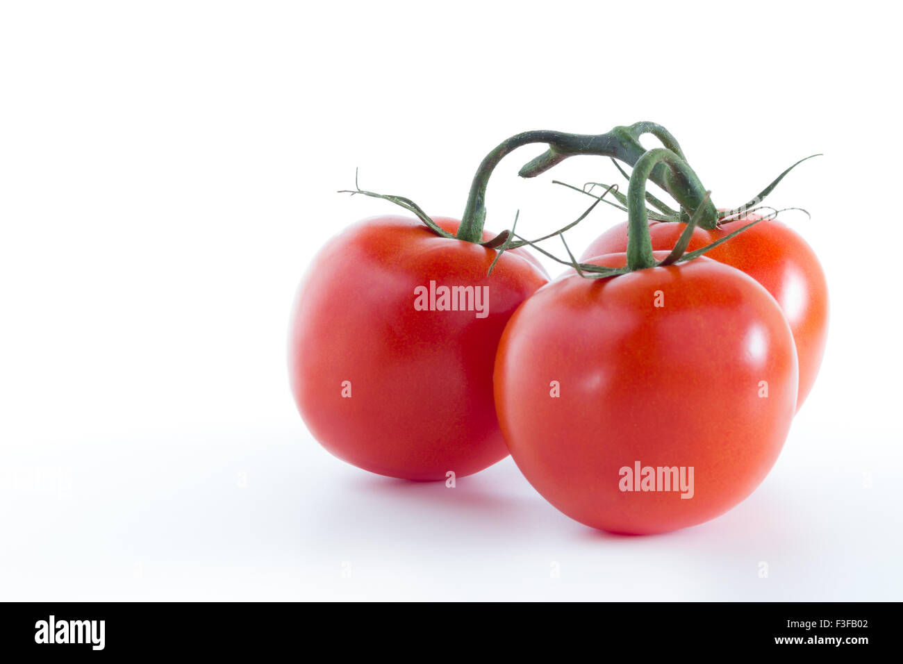 Three ripe tomatoes, isolated on white background Stock Photo - Alamy