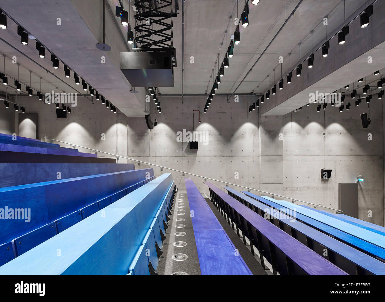 View across lecture room with blue colored tiers. Greenwich School of Architecture, London, United Kingdom. Architect: Heneghan Stock Photo