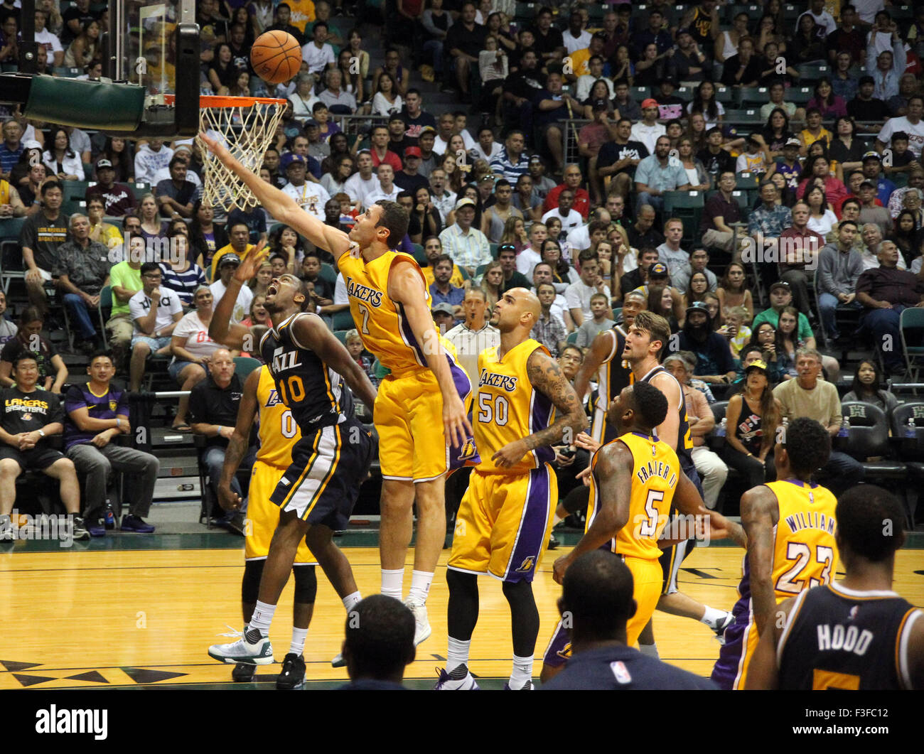 Hawaii, USA. 7th October, 2015. October 6, 2015 - Utah Jazz guard Alec Burks #10 slpits Los Angeles Lakers forward Larry Nance Jr. #7 and Los Angeles Lakers center Robert Sacre #50 for two points during preseason action between the Los Angeles Lakers and the Utah Jazz at the Stan Sheriff Center on the campus of the University of Hawaii at Manoa in Honolulu, HI. - Michael Sullivan/CSM Credit:  Cal Sport Media/Alamy Live News Stock Photo