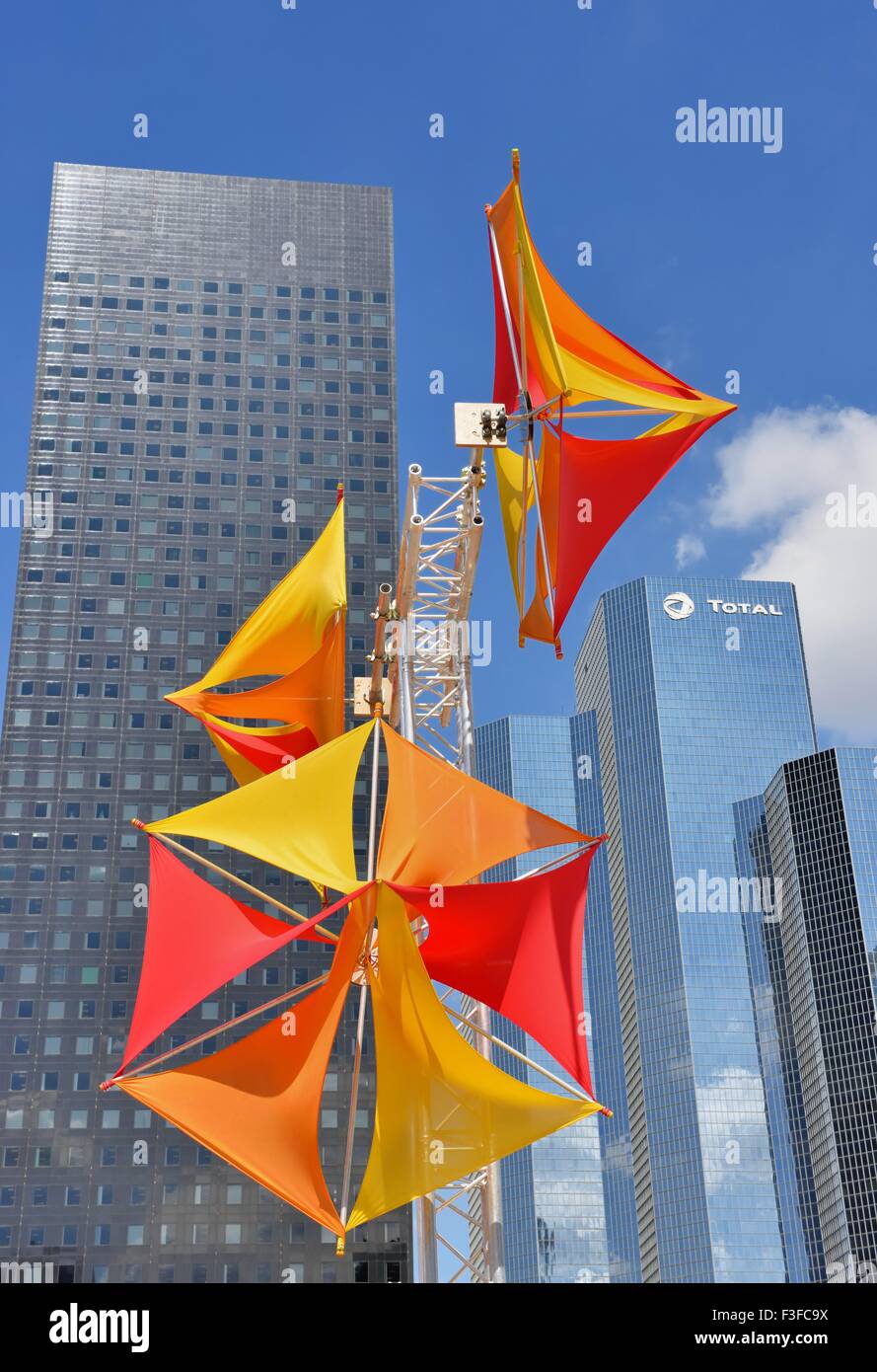 Colorful windmills, modern artwork on Voie des Sculptures, modern office buildings behind, La Defense, Nanterre, Paris Stock Photo
