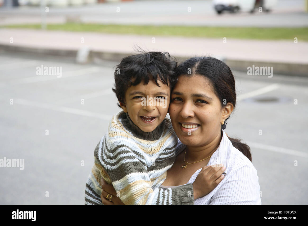 Mother carrying four years old son making faces and smiling MR#468 Stock Photo