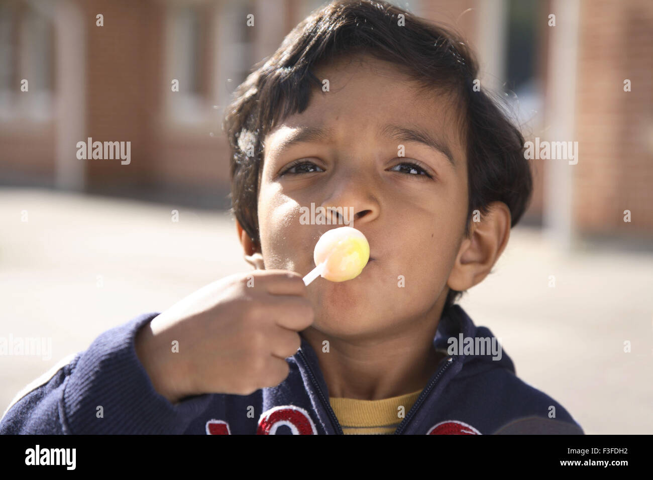 Small four years old boy kissing testing and eating lollipop MR#468 Stock Photo
