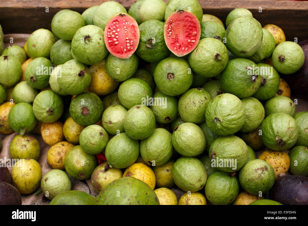 Guava ; an edible pale orange tropical fruit with pink ; juicy flesh and a strong ; sweet aroma Stock Photo