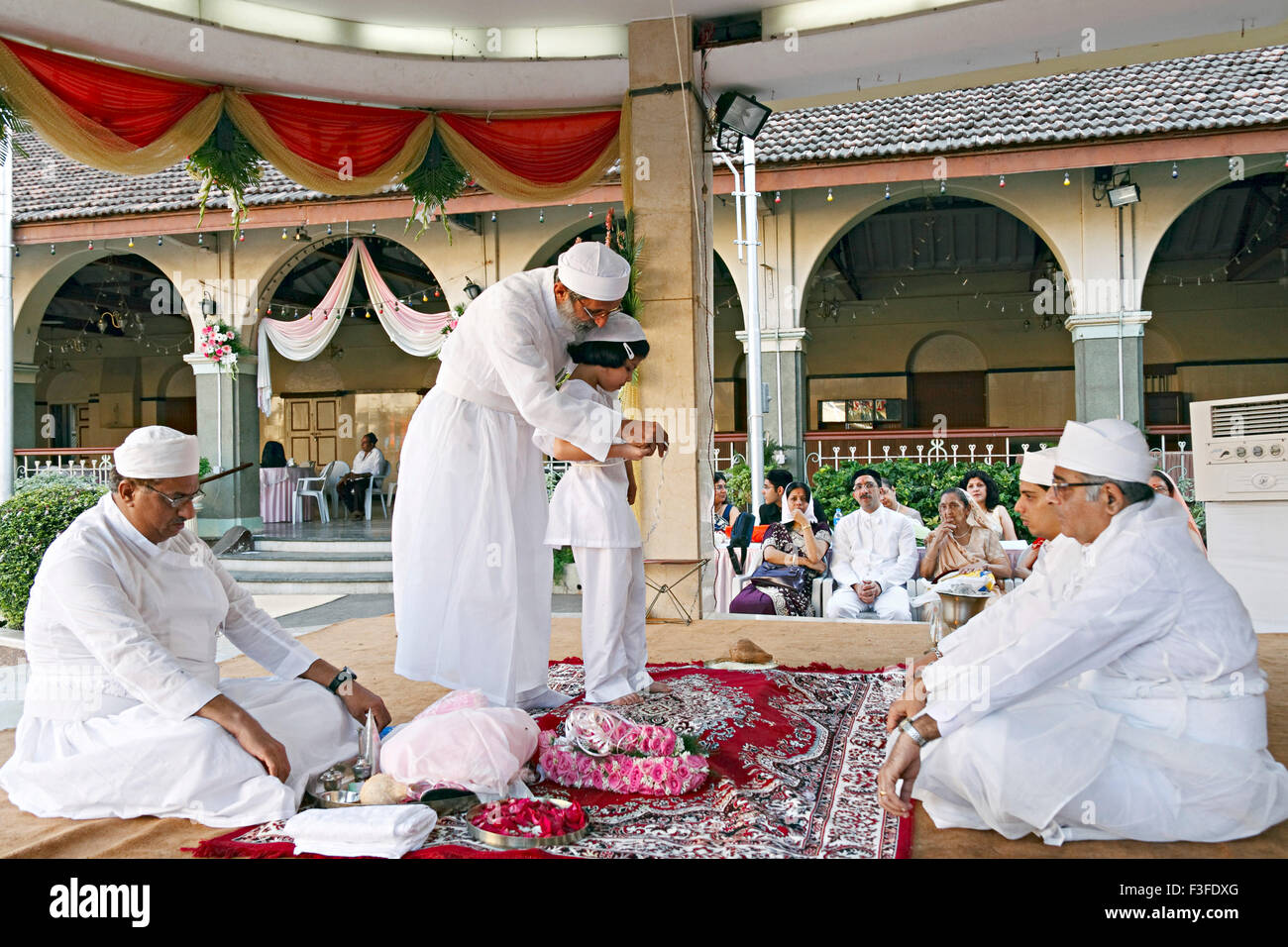 Tying the Kushti ; Ritual ; Parsi Navjot a thread ceremony ; India MR