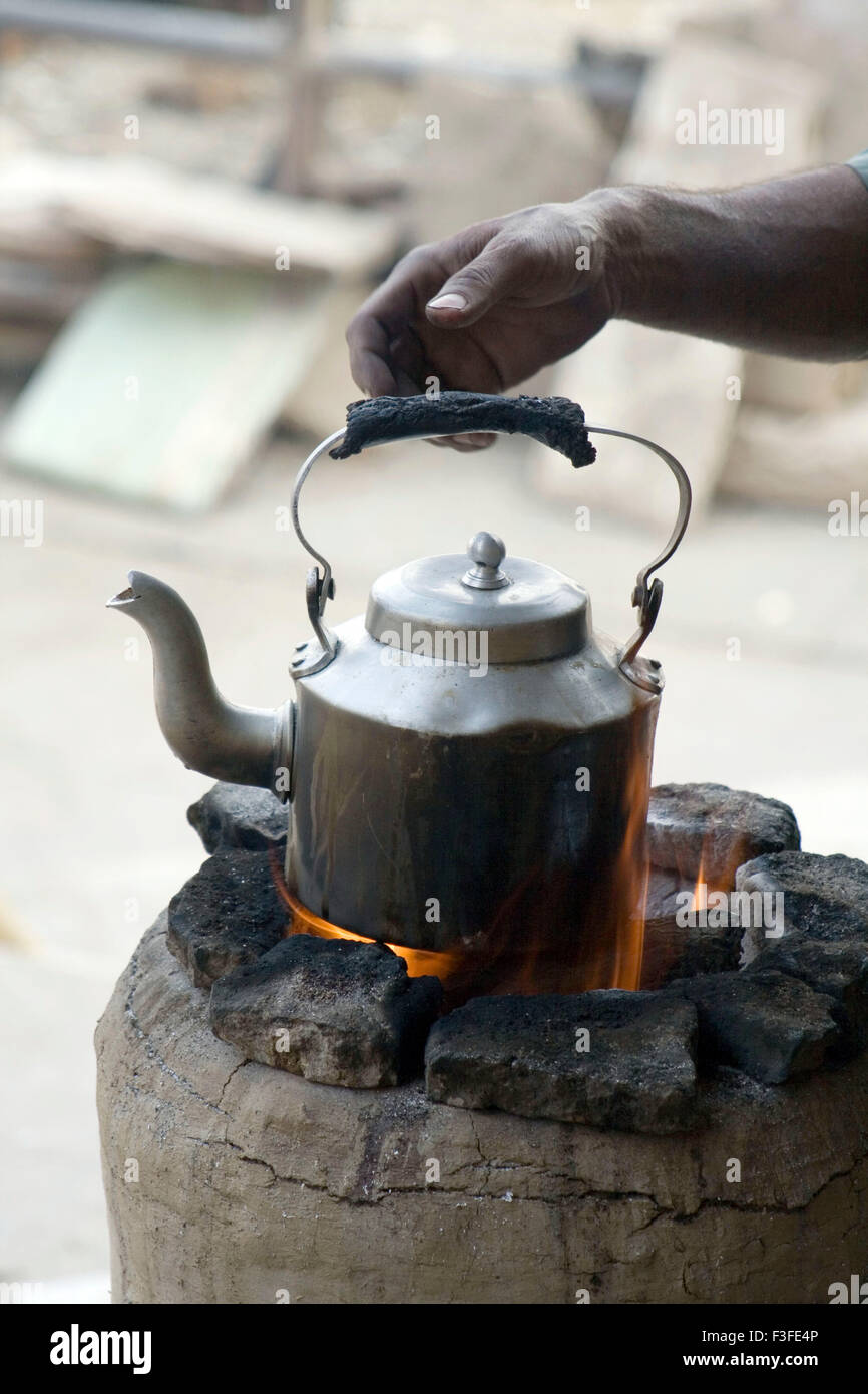 Tea pot on coal fire Stock Photo - Alamy
