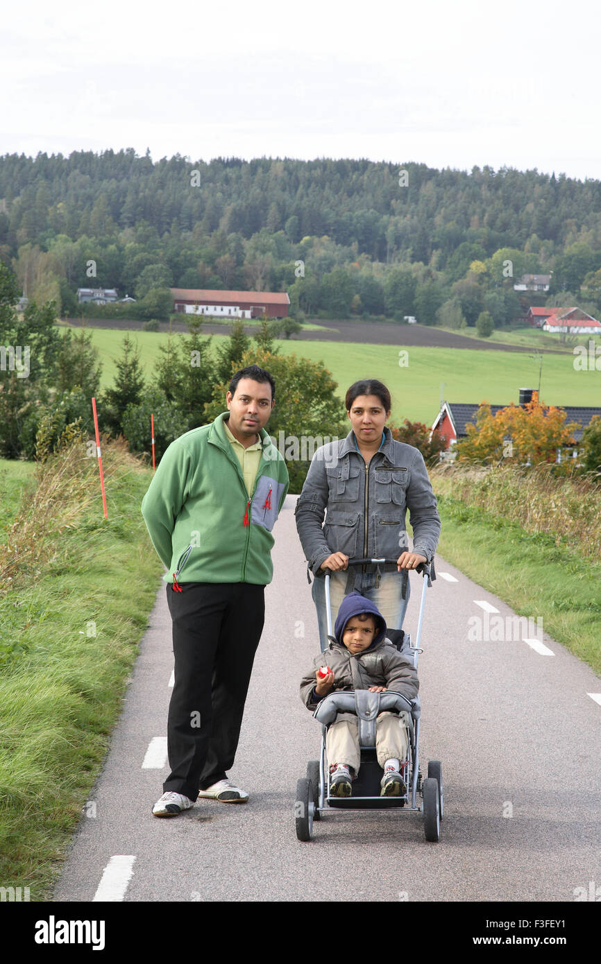 Parent with four years old son in pram on small street ; Sweden MR#468 Stock Photo