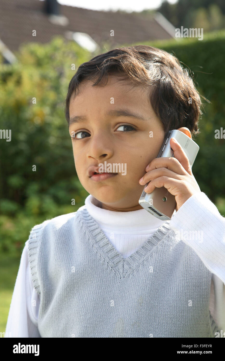 Four year old boy speaking on mobile phone MR468 Stock Photo Alamy